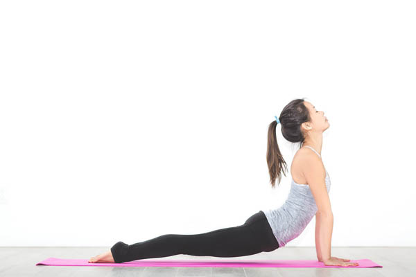 Yoga pose on a pink mat 600