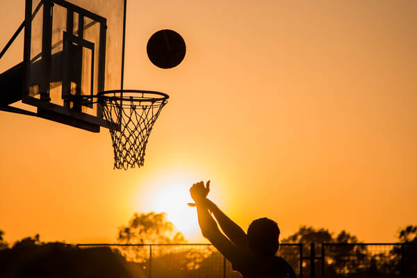 Playing basketball while the sun is going down