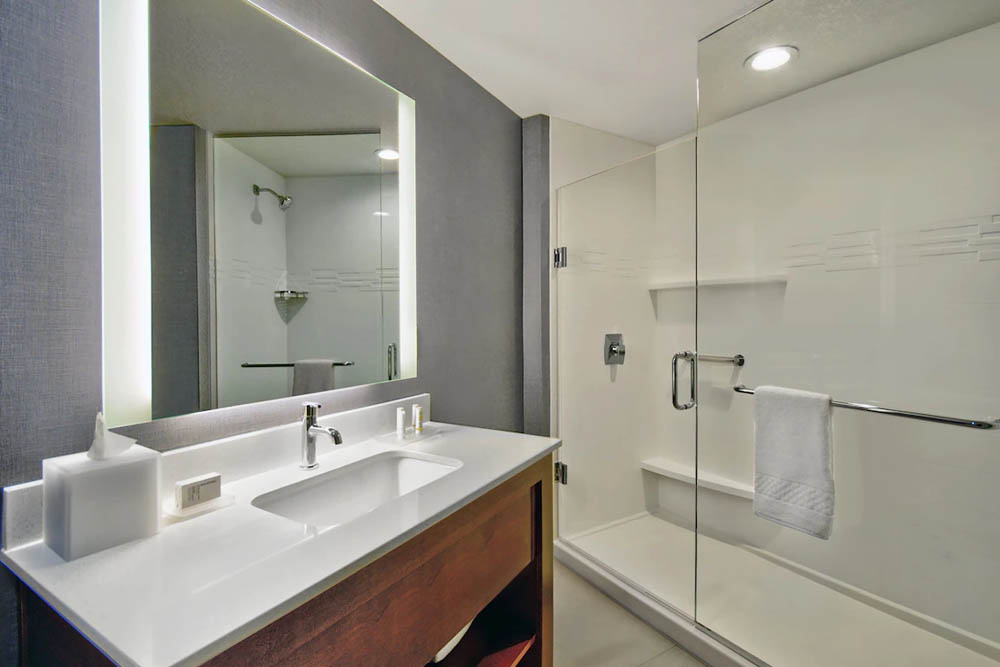 Large bathroom with walk-in shower in the studio suite at Residence Inn at Flamingo Crossing in Orlando 1000