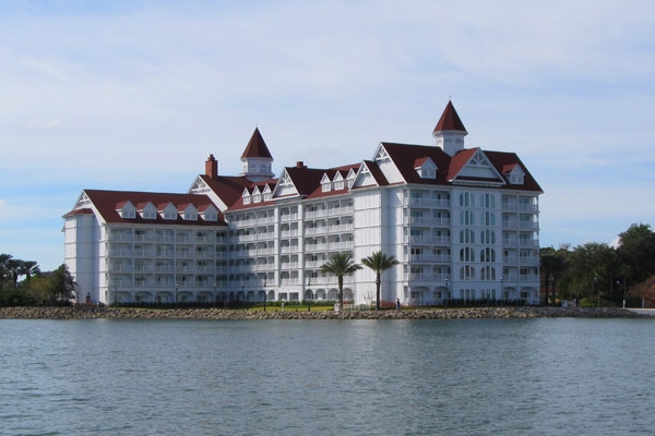 View of a large building for accommodations at the Disney Grand Floridian from the lake on a boat