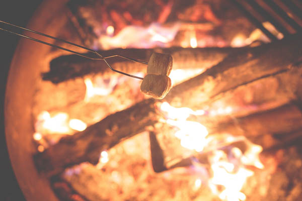 Sitting around the campfire and roasting marshmallows