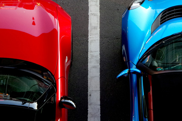 Red and Blue cars in parking lot