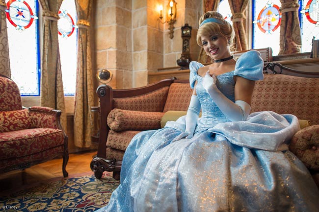 Cinderella sitting on a sofa in the Cinderella Castle Suite in Disney World