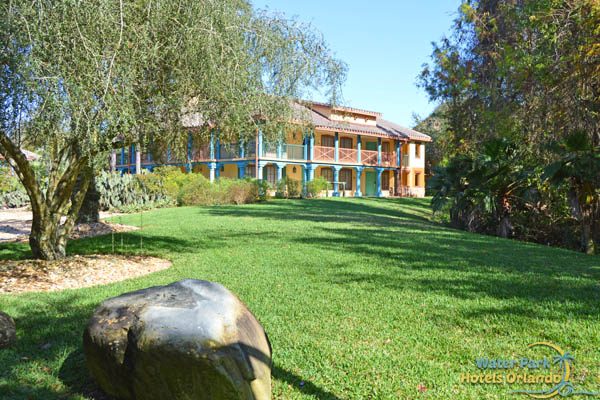 The Ranchos Village through a grassy area at the Disney Coronado Springs Resort 600