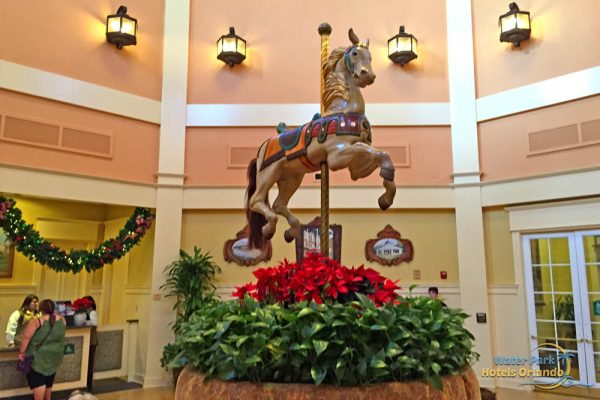 Poinsettias surrounding the carousel horse in the lobby at the Disney Saratoga Springs Resort 1000