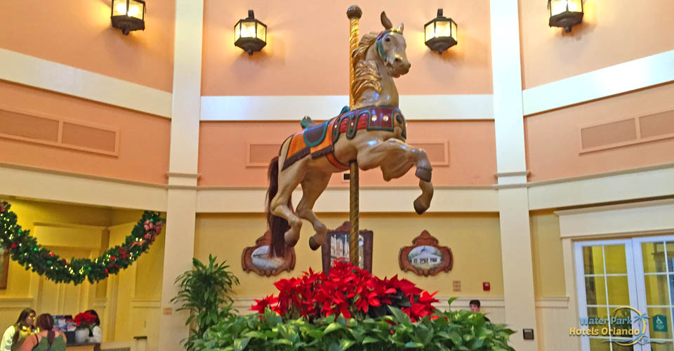Poinsettias surrounding the carousel horse in the lobby at the Disney Saratoga Springs Resort 960