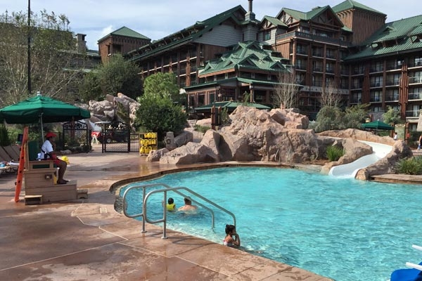 View of the Disney Wilderness Lodge Silver Springs Pool with Water slide and Lifeguard watching over 600