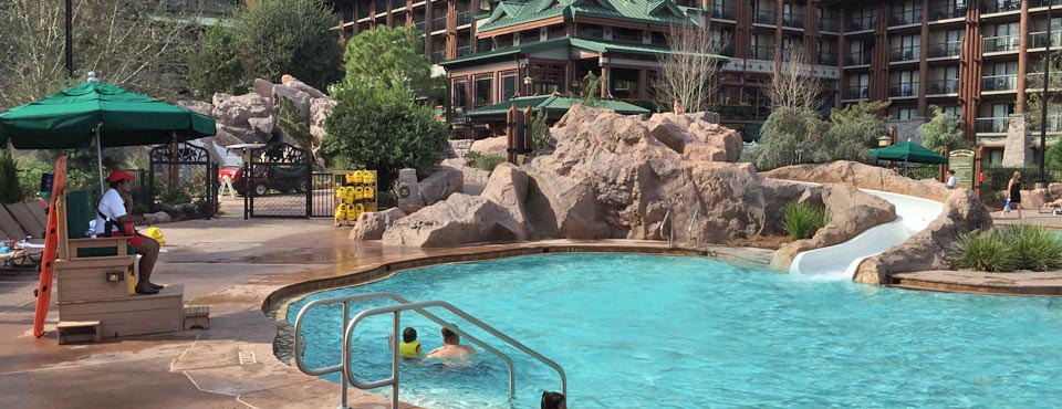 View of the Disney Wilderness Lodge Silver Springs Pool with Water slide and Lifeguard watching over 960