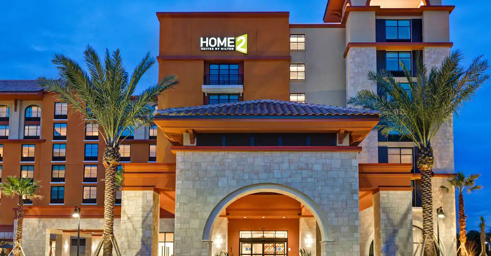 Front entrance evening to the Home2 Suites in Flamingo Crossing a Hilton Hotel 960