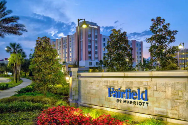Entrance at dusk with a lighted sign at the Fairfield Inn and Suites Flamingo Crossing 1000