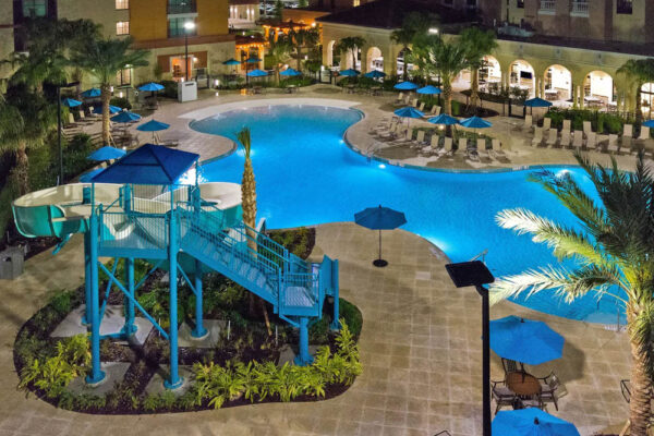 Outdoor Pool with Water Slide in the evening at the Flamingo Crossing Homewood Suites Orlando 1000