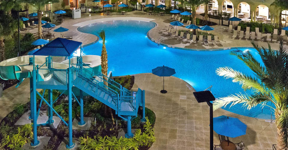 Outdoor Pool with Water Slide in the evening at the Flamingo Crossing Homewood Suites Orlando 960