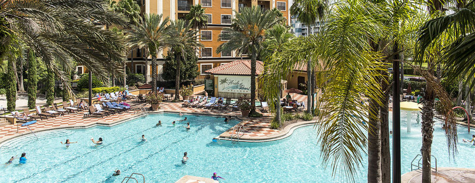 View of the Grand Pool from above with Palm Trees all around and the Lap Pool in view wide