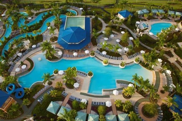 View of the full water fun area with 2 Swimming Pools, Water Slide, Lazy River and Cabanas at The Hilton Orlando 600