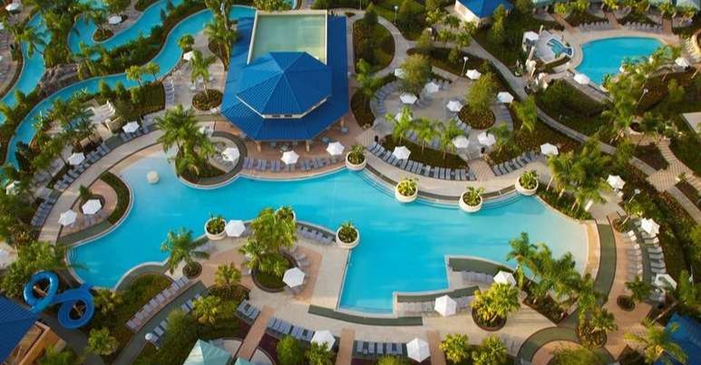 View of the full water fun area with 2 Swimming Pools, Water Slide, Lazy River and Cabanas at The Hilton Orlando 960