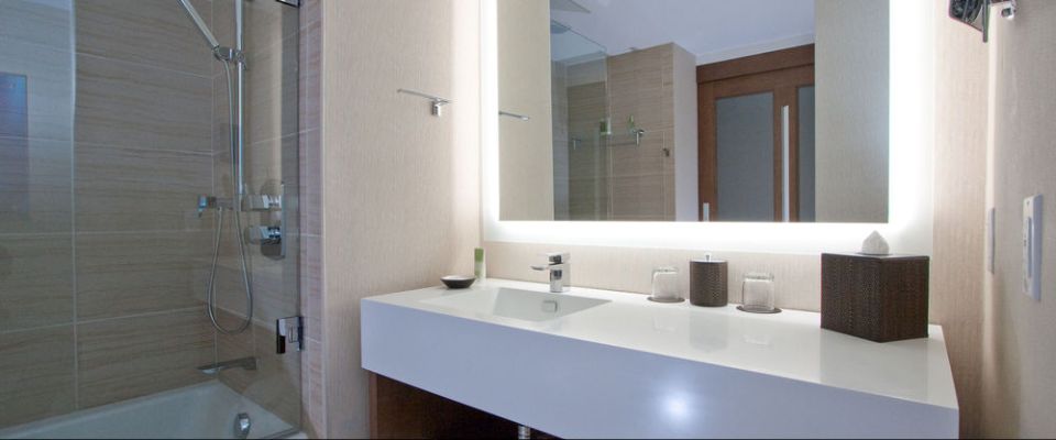 Elegant Bathroom at the Hyatt Regency Grand Cypress with solid sink top, tub and Shower unit