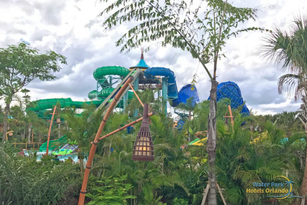 Honu Ika Moana group water slides from a distance in the park through trees at the Volcano Bay Water Park Orlando 1000