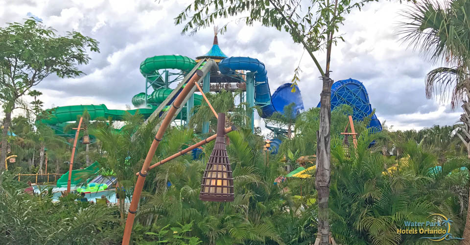 Honu Ika Moana group water slides from a distance in the park through trees at the Volcano Bay Water Park Orlando 960
