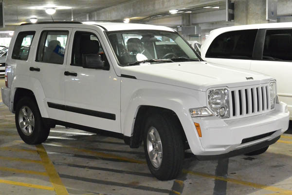 White Jeep in a parking garage 600