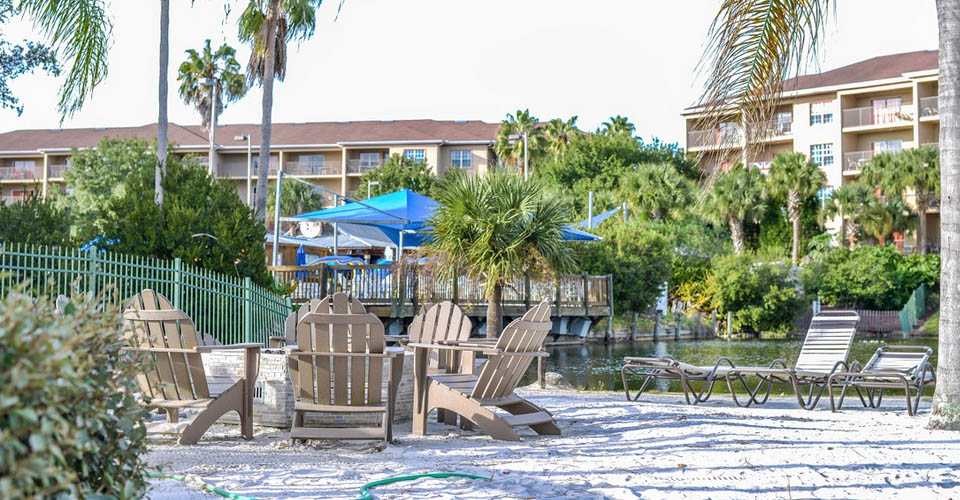 Chairs sitting on tranquil beach by the lake at the Liki Tiki Resort in Orlando 960