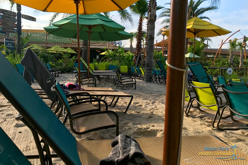 Lounge Chairs in the sand in front of  Cabana at the Volcano Bay Water Park 1000