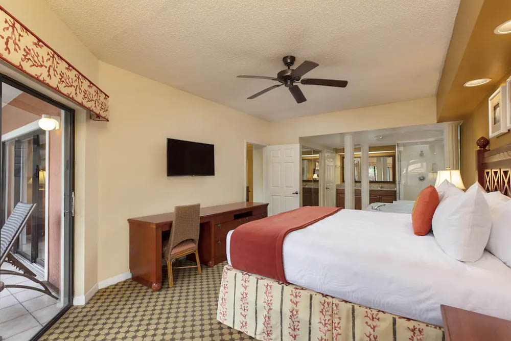 Master Bedroom with desk, ceiling fan and connection to the jetted tub in the room in the 2 Bedroom Villa at the Marketplace at the Westgate Lakes Resort Orlando 1000