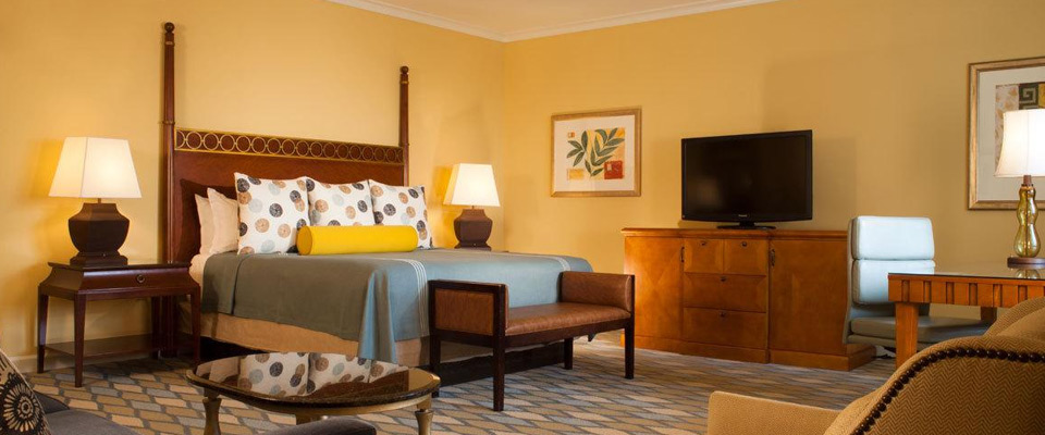 View of a Deluxe Executive Room with Sofa, Chair and Desk at the Omni Orlando ChampionsGate Resort
