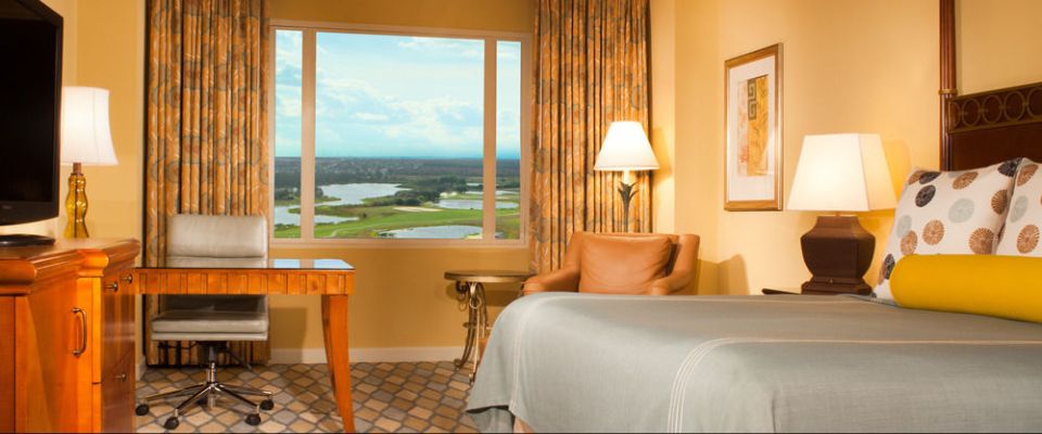 View of a Deluxe King Room with King Bed Desk and Chair with Picture Window at the Omni Orlando ChampionsGate Resort