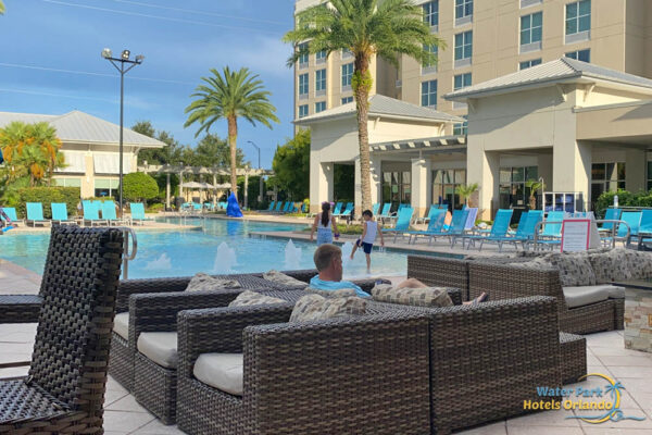 Outdoor pool with comfortable seating at the TownPlace Suites in Flamingo Crossing 1000