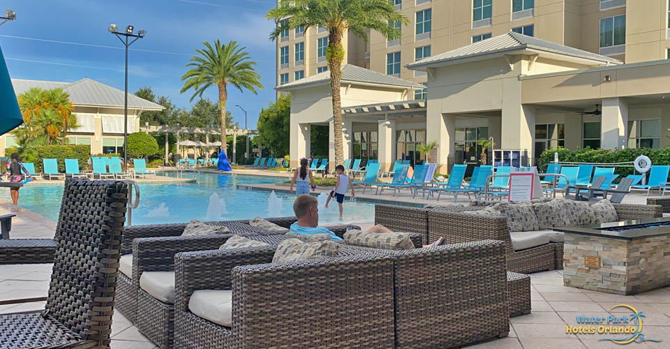 Outdoor pool with comfortable seating at the TownPlace Suites in Flamingo Crossing 960