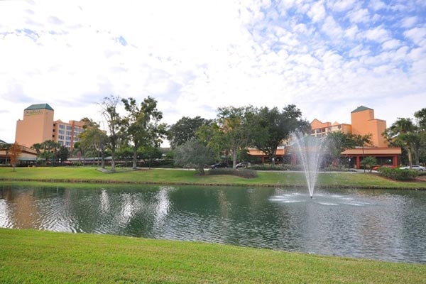 View of the grounds with lake and water features in front of the Radisson Resort Orlando Celebration 600
