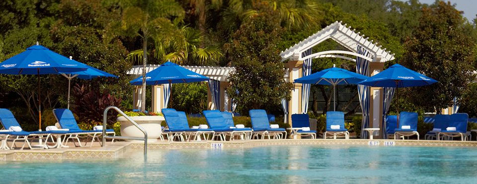 Renaissance Hotel Orlando SeaWorld Outdoor Pool with Blue Umbrellas and Lounge Chairs wide