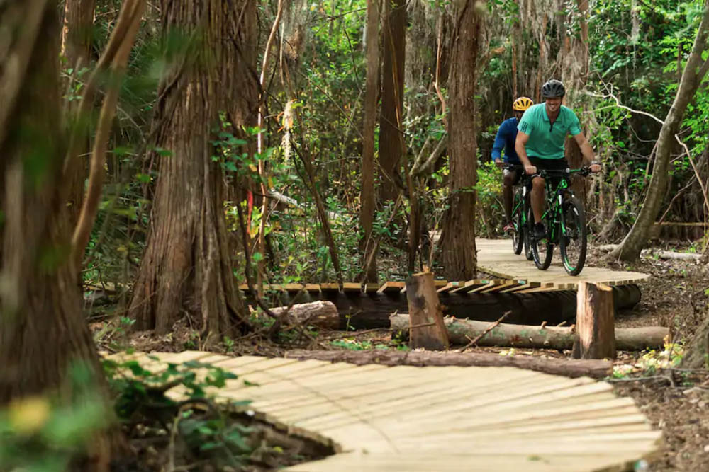 Mountain Bike trail with riders on the wooden path at the Ritz-Carlton Grande Lakes Resort in Orlando
