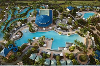 View of the full water fun area with 2 Swimming Pools, Water Slide, Lazy River and Cabanas at The Hilton Orlando