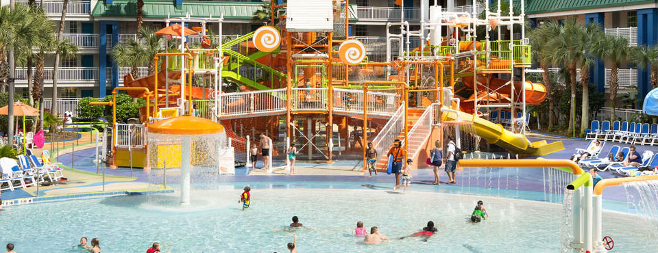 View of the large water park zone with zero entry pool and water slides at the Holiday Inn Resort Orlando Suites Water Park