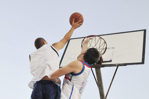 Basketball players shooting hoops