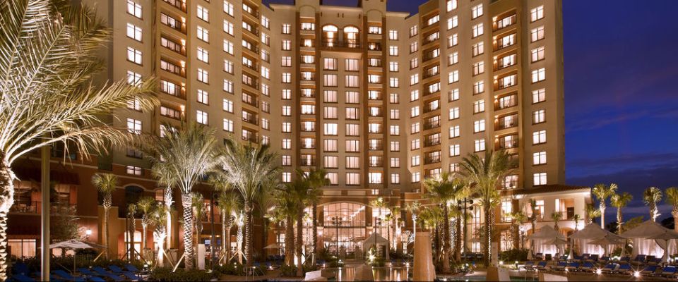 Evening View of the Wynham Grand Orlando at Bonnet Creek lit up from the Pool with Cabanas in the background 960